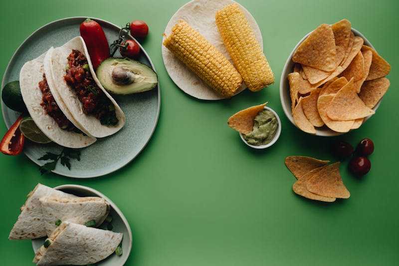 Three carne asada tacos on corn tortillas