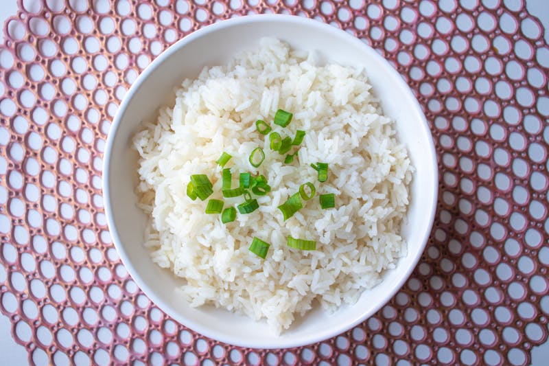 Fluffy cilantro lime rice garnished with fresh herbs